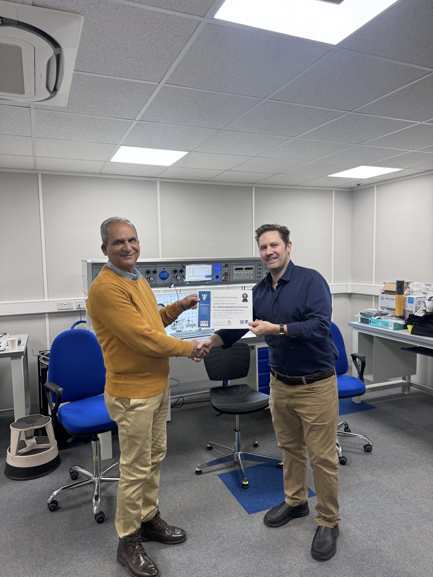 Farooq Mahmood Al Obaidi receiving his certificate from Robert Bailey.