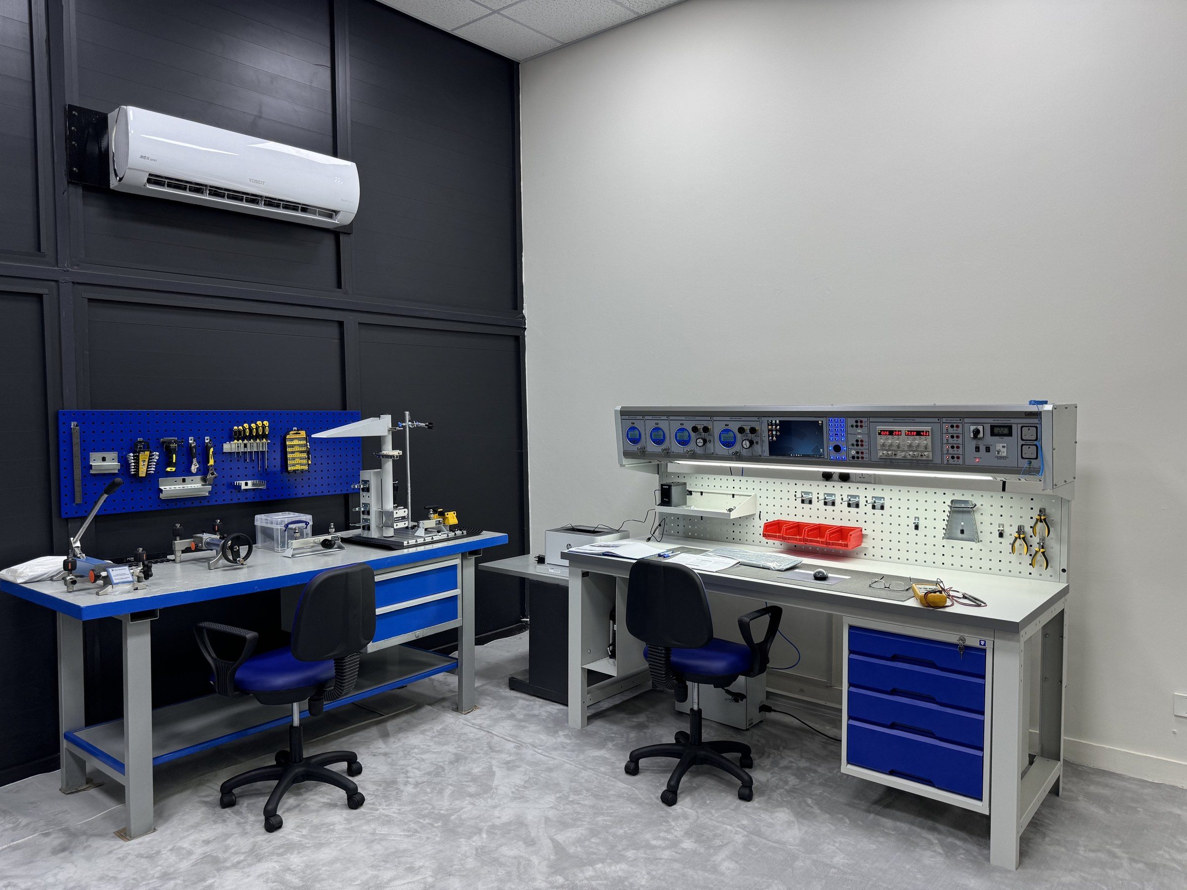 The finished calibration room, with the CalBench and its workstation against dark and white walls.