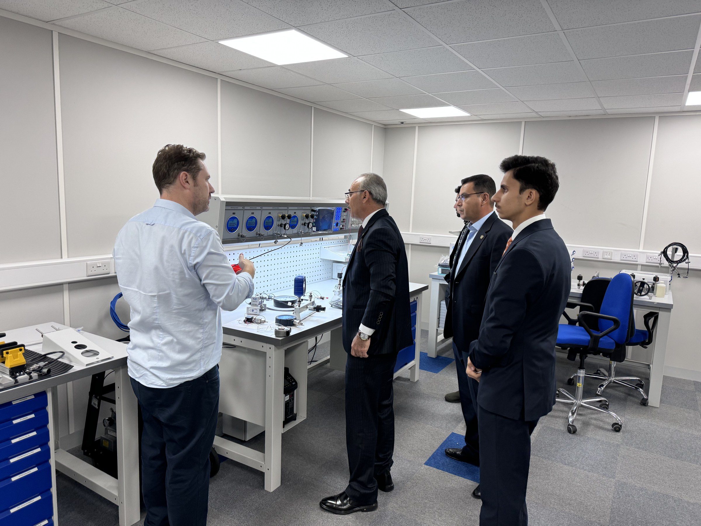 Robert Bailey at a calibration bench with the North Gas Company and ITS delegation.